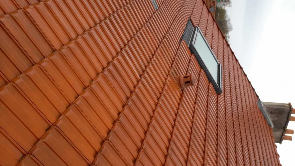 Pose de tuiles neuves sur liteaux lors d'une installation de toiture en Essonne